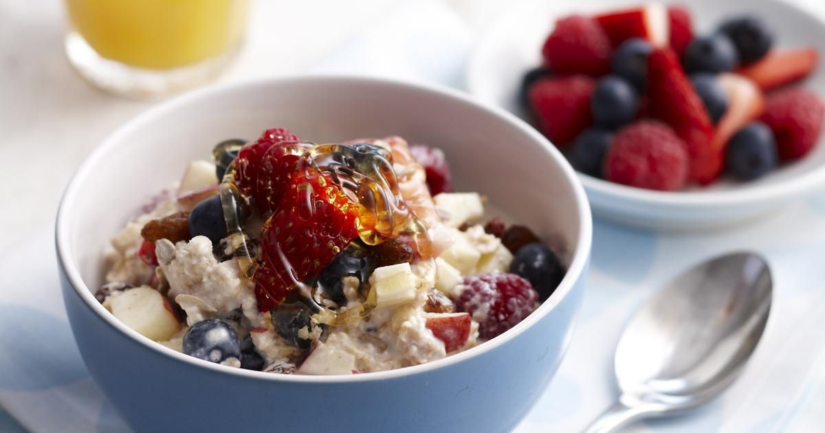 A bowl of oatmeal topped with fresh berries and fruit, showcasing a nutritious high-protein breakfast option.