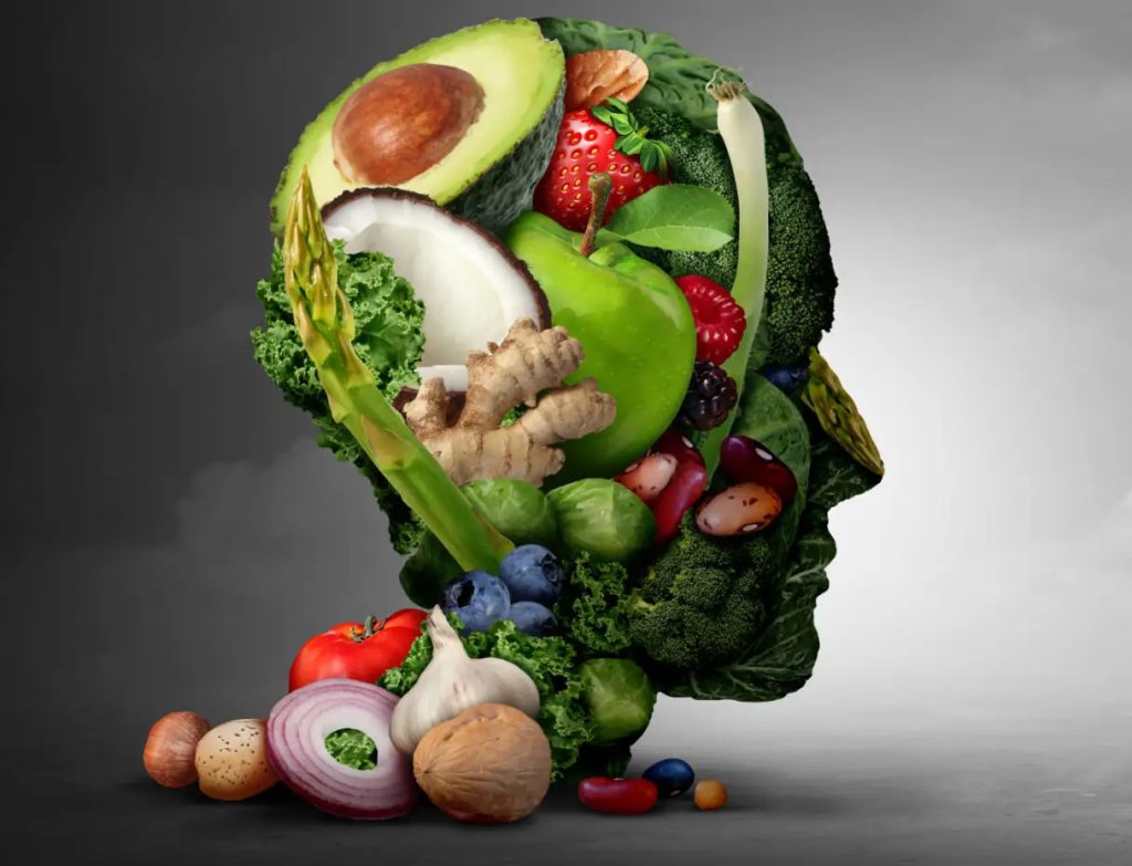 A head-shaped arrangement of fruits and vegetables symbolising mental health dietitian services and nutrition support