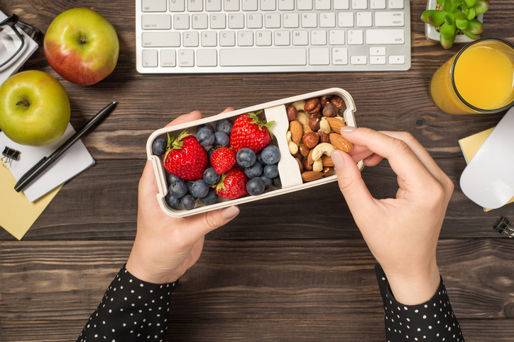 Healthy snacks at a desk, representing corporate nutrition programs and workplace dietitian services